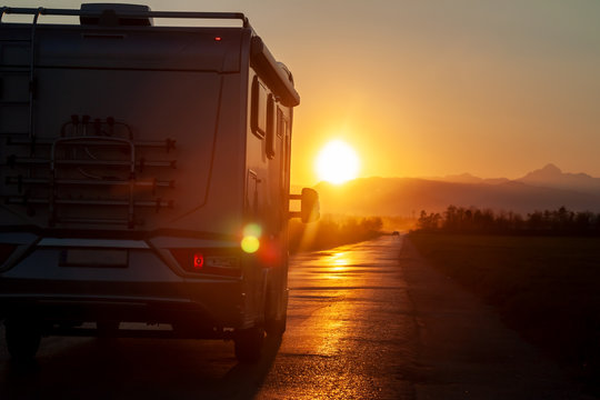 campervan on the road heading to sunset