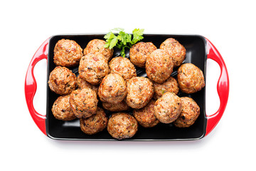 Meatballs in frying pan isolated on white background.