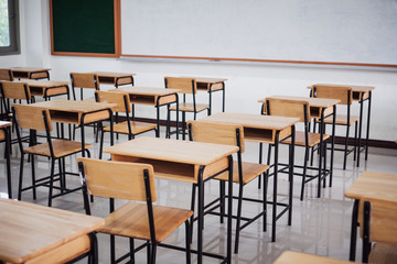 School empty classroom or lecture room interior with desks chair iron wooden whiteboard for studying lessons of secondary education in high school thailand. Learning and Back to school concept