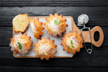 Fresh homemade delicious vanilla muffins with powdered sugar.