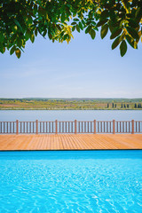Photo of a swimmig pool at handsomea hotel, with beautiful landscape to lake