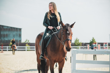 Fototapeta premium Woman in a rancho with a horse. Hobby time 