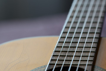 Fototapeta premium Old acoustic guitar with cracks on the soundboard close up