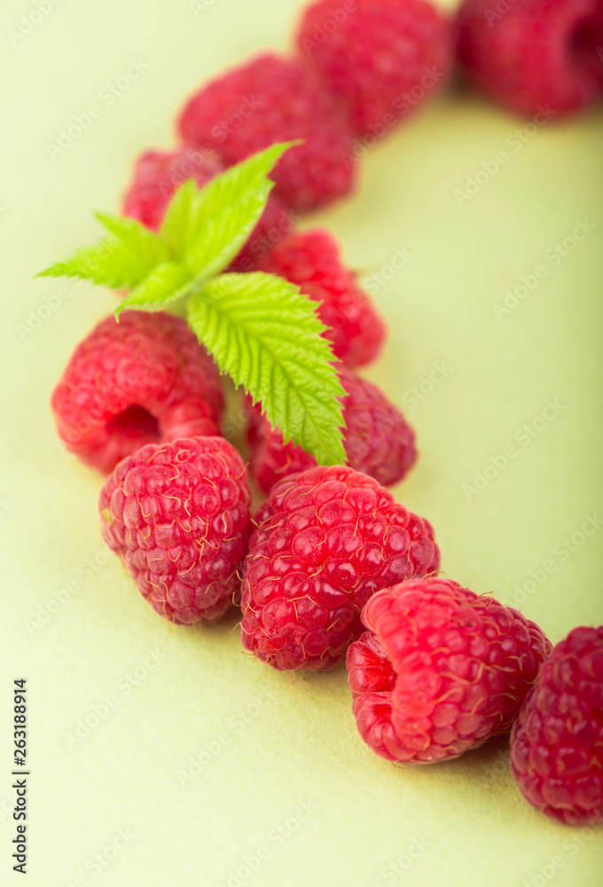 Poster wreath made of raspberries on white background