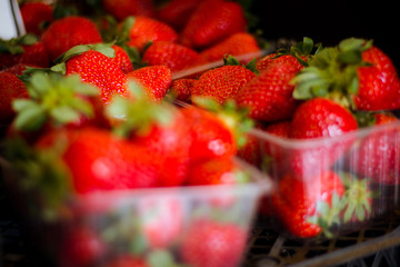 Fresh strawberry in plastic box at market