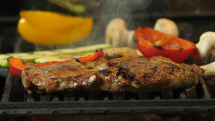 Closeup of a grilled steak cooked together with vegetables