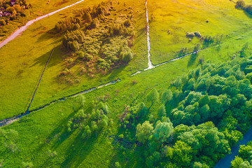Top view of the countryside, winding river, and irrigation ditches in spring