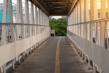 Overpass for walk across the road with light on right side.