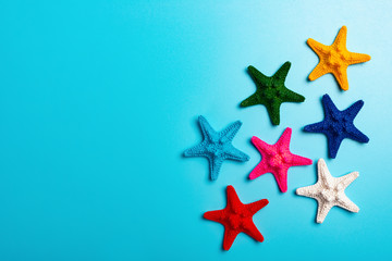 Fototapeta na wymiar multi color starfishes on blue background
