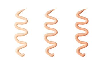 Foundation of different shades, extruded by a snake on a white background - isolate