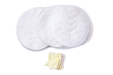 Refreshing skin care cream and cotton pads on white background, isolate. © Elena