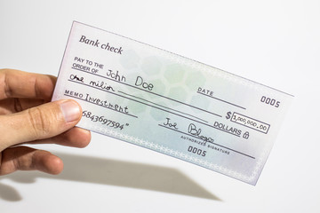 Holding a million dollar bank check isolated in a white background