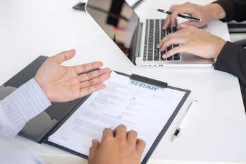 Employer arriving for a job interview, businessman listen to candidate answers explaining about his profile and colloquy dream job, manager sitting in job Interview talking in office
