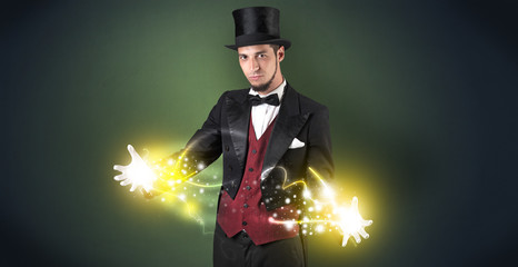 Magician holding his sparkling power between his two hand