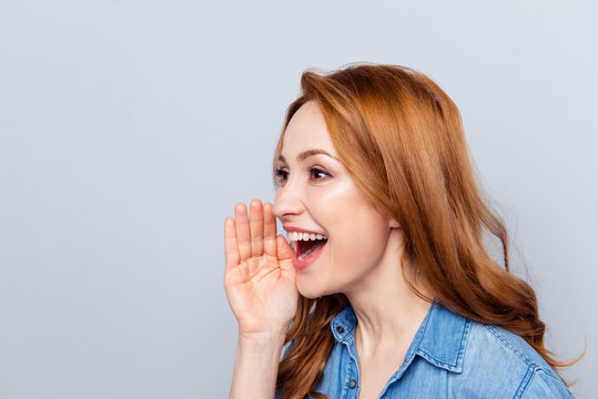 Close up side profile photo beautiful she her curly lady spread news novelty chatterbox hold arm hand near mouth help tell speak louder wear casual blue jeans denim shirt isolated grey background