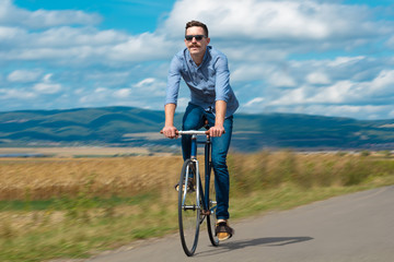 Natural view with cyclist going somewhere with stylish bike