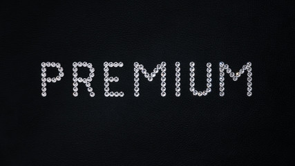 Word Premium made of shiny white swarovski crystals placed on black leather