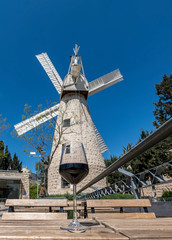 Fototapeta na wymiar Montefiore windmill, Jerusalem. View from a coffee shop. The windmill is a famous municipal museum and public domain in Israel 