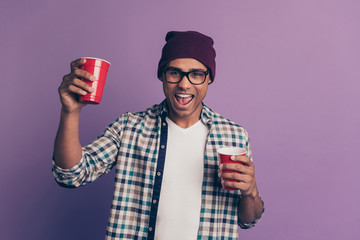 Photo portrait of crazy funky guy enjoying holiday weekend holding raising plastic glass with...