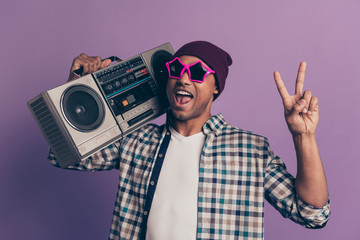 Closeup photo portrait of funny funky nice handsome carefree careless excited screaming ecstatic student holding player on shoulder give v-sign isolated violet background