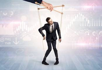 Puppet businessman controlled by another hand with financial concept
