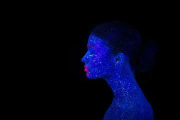 Profile of an alien woman with blue skin and pink lips, ultraviolet makeup on a black background.