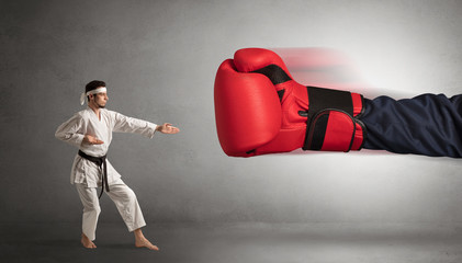 Little man fighting with a giant red boxing glove
