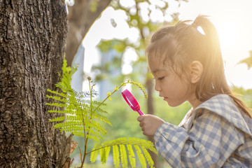 girl looking for insect in garden