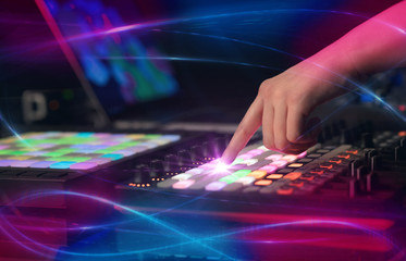 Obraz na płótnie Canvas Hand mixing music on midi controller with wave vibe concept 