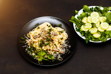 Delicious dinner or lunch on a black wooden background, close-up