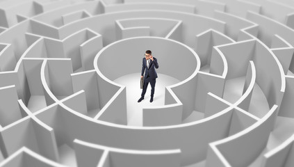 Young businessman standing in a middle of a 3d round maze
