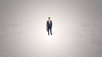 Young businessman standing alone in the middle of an empty space
