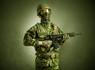 Soldier agent in a dark room with arms on his hand and gas mask
