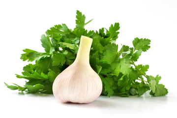 Fresh young garlic and green parsley on a pure white background