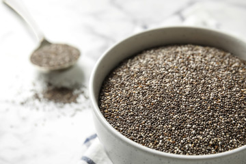 Bowl with chia seeds on table, closeup. Space for text
