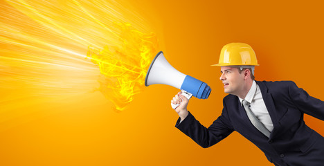 Fototapeta premium Young architect constructor yelling with megaphone with copyspace