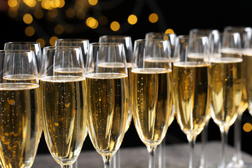 Many glasses of champagne on blurred background, closeup