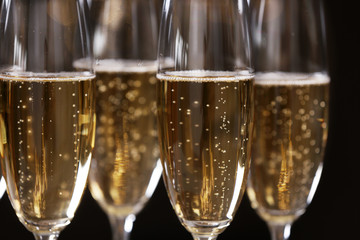 Glasses of champagne on dark background, closeup