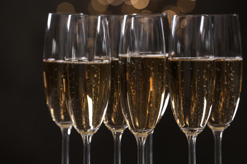 Many glasses of champagne on blurred background, closeup