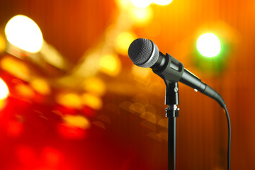 Obraz premium Microphone against festive lights, space for text