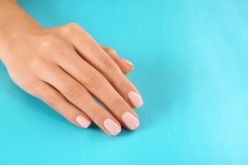 Beautiful female hand on color background, closeup with space for text. Spa treatment