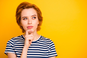 Close up photo beautiful she her lady look up empty space sly hand arm chin think over deep dreamer wearing casual striped white blue t-shirt outfit clothes isolated yellow bright vibrant background