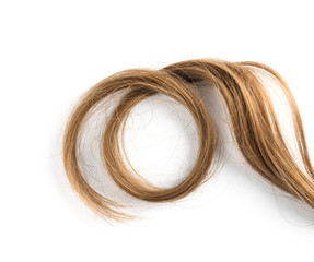 Strand of beautiful light brown hair on white background, top view. Hairdresser service