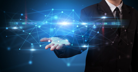 Handsome person holding hologram screen displaying modern cloud based web system technology
