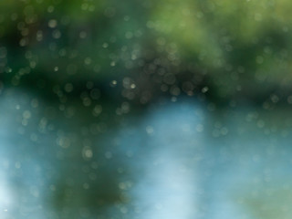 A cloud of mosquitoes beside the river on a bokeh background