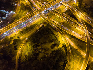 Fototapeta na wymiar Curve of expressway at night traffic with vehicle transport