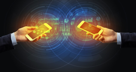 Close up of two smartphones syncing business data