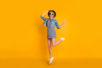 Fototapeta na wymiar Full length body size photo foxy she her chic lady jumping high sunny day off fine weather weekend wear specs vintage hat casual striped t-shirt dress jeans denim isolated yellow bright background