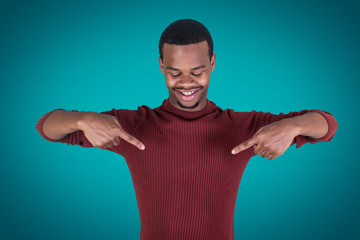 Naklejka premium Smiling man looking and pointing at chest