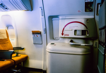 Aircraft interrior with the airplane's entrance, the flight attendant seat and emergency door exit